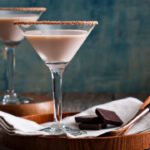 Creamy Chocolate Martini 10 chocolate martini on a tray with pieces of chocolate