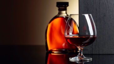 glass and bottle of flavored brandy
