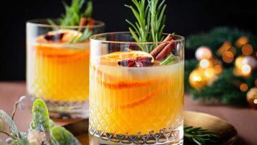 Winter warming bourbon old fashioned cocktail with oranges, cinnamon and rosemary