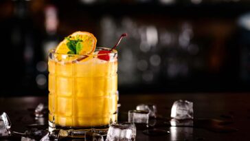 Gold Rush Cocktail Rob Roy on the background