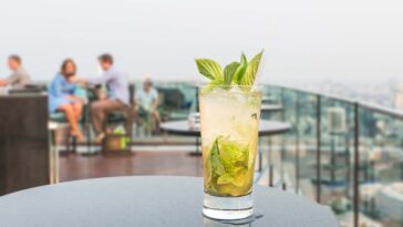 cocktail on table at rooftop bars in Chicago
