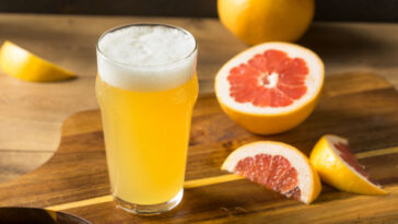 glass of sour beer with citrus fruit