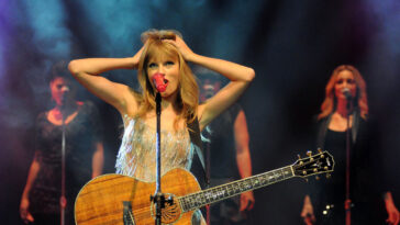 taylor swift singing on stage at a concert