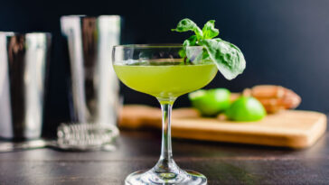 Thai Basil Gimlet Cocktail with Garnish: A gin cocktail in a coupe glass