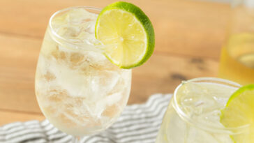 a citrus wine spritzer with lime garnish