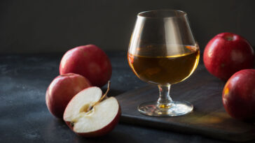 glass of calvados with sliced apples