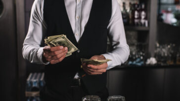a bartender counting tips