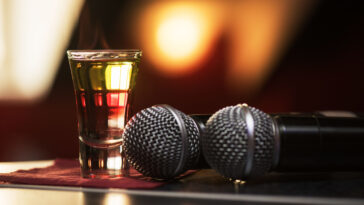 two microphone with a drink on the table at a karaoke bar in los angeles