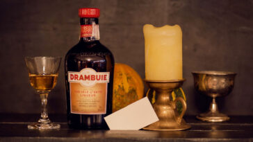 bottle and glass of drambuie with candles