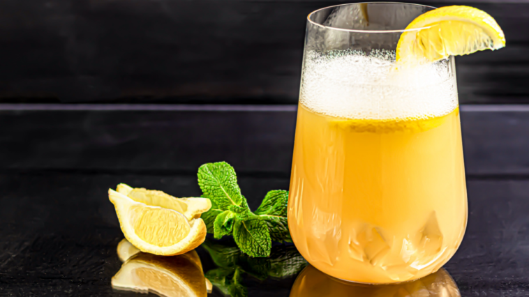 lemon rum cocktail with lemon wedge and mint garnish