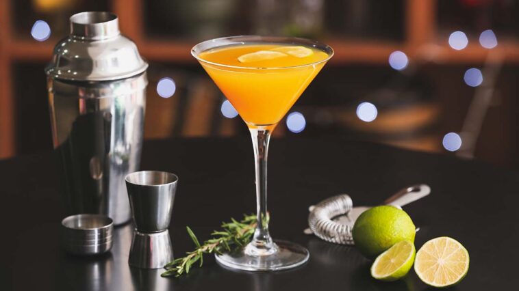 Glass of tasty mango margarita on table in bar