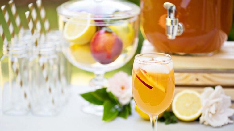 Peach lemonade in a glass on the outdoor party drink station