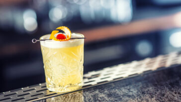 Cocktail drink whiskey sour at barcounter in night club