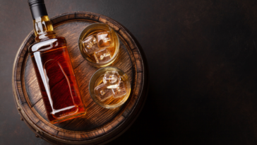a bottle and two glassed of best 15 year bourbons