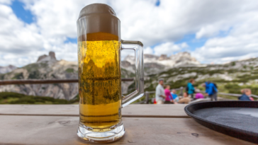 Mug of beer with dolomitic background