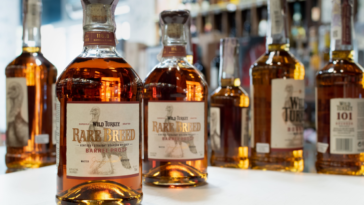 Bottle of Wild Turkey Rare Breed Kentucky Straight Bourbon Whiskey on blurred background of bottles