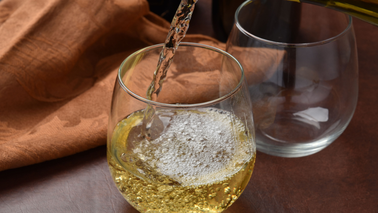 Pouring pinot grigio wine into a glass