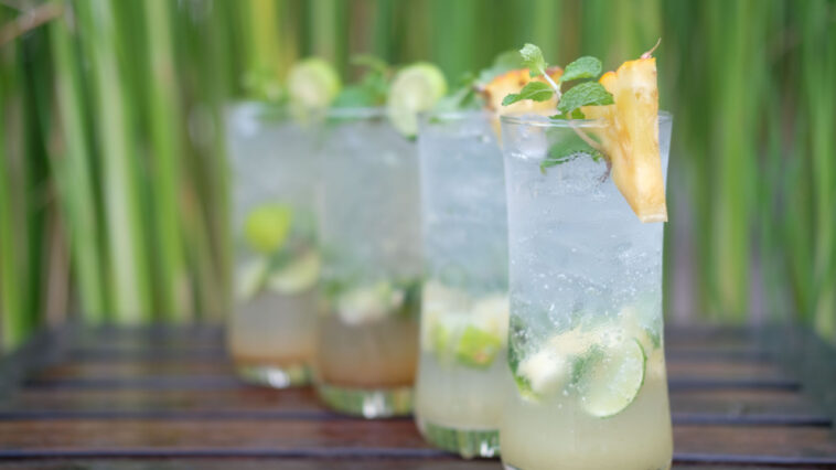 pineapple mojito mocktail and lime mojito cocktail on wooden table