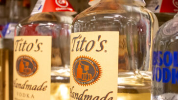 A view of several bottles of Tito's Handmade Vodka, on display at a grocery store.