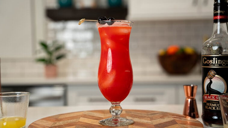 rum punch cocktail with ingredients on the background