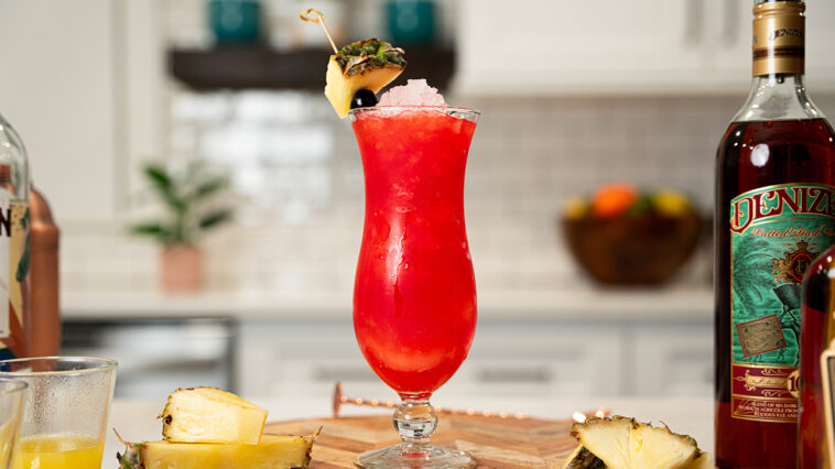 Rum Runner 1 rum runner cocktail with ingredients at the background